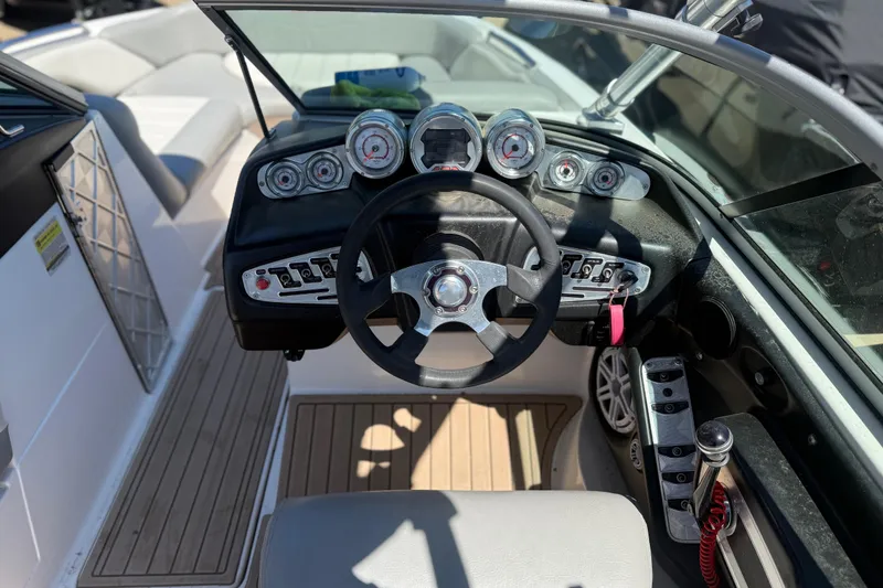 Slide: The Image of 2008 MasterCraft X-45 boat dashboard with steering wheel and gauges. - 10