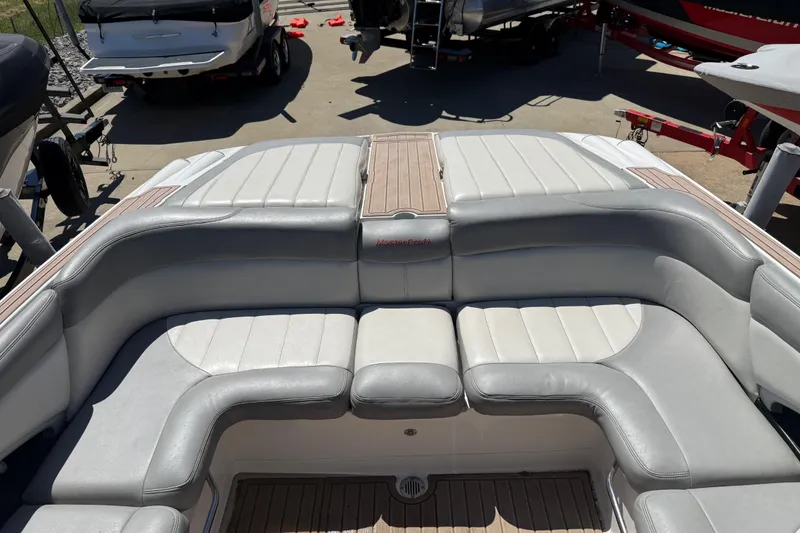 Slide: The Image of 2008 MasterCraft X-45 boat interior with gray seating and wood accents. - 11