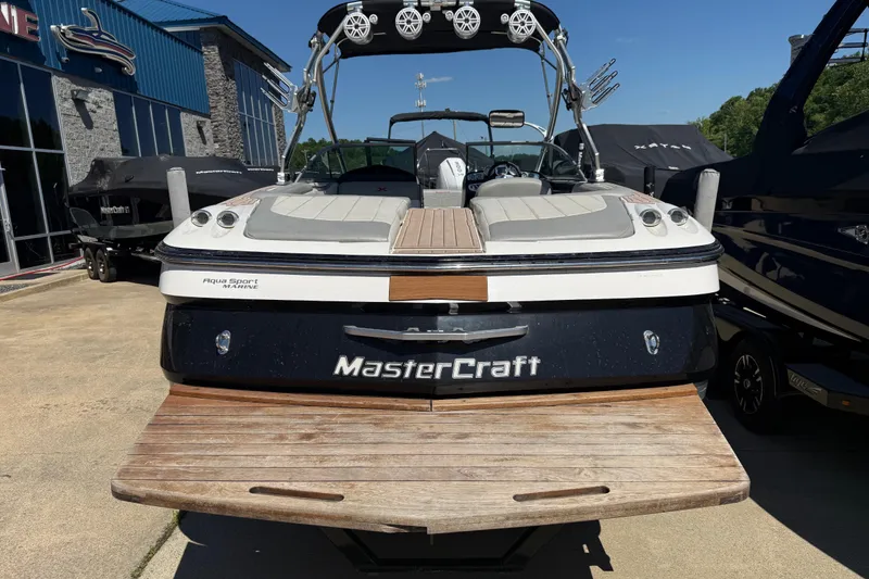 Slide: The Image of 2008 MasterCraft X-45 boat with teak swim platform, parked at a marina. - 19