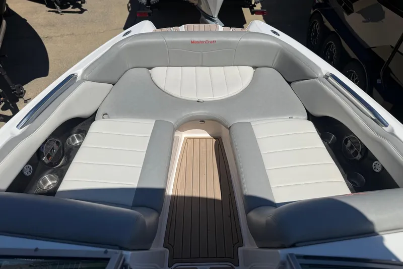 Slide: The Image of 2008 MasterCraft X-45 boat interior with gray and white seating, cup holders, and teak flooring. - 3