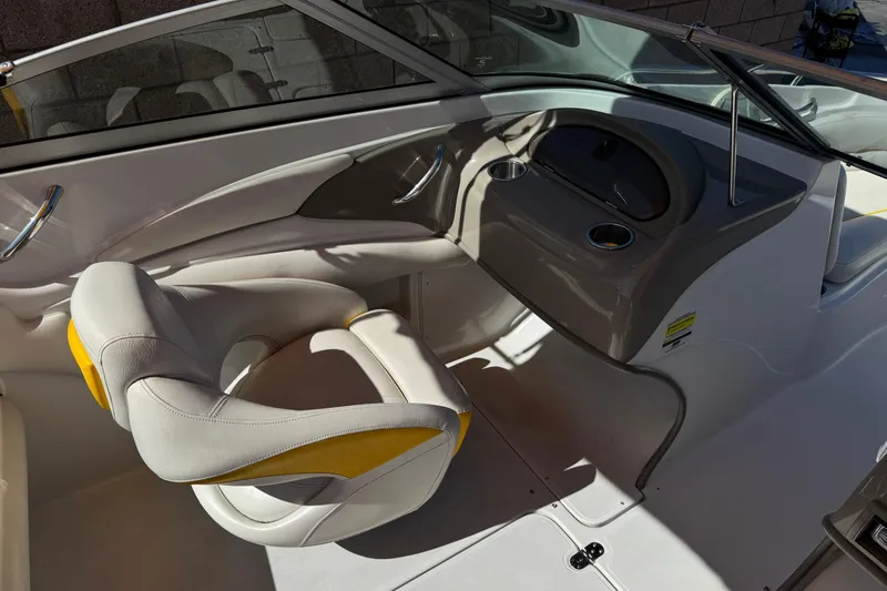 Slide: The Image of Interior of a 2008 Crownline 200 LS boat, featuring a stylish helm and seating. - 19