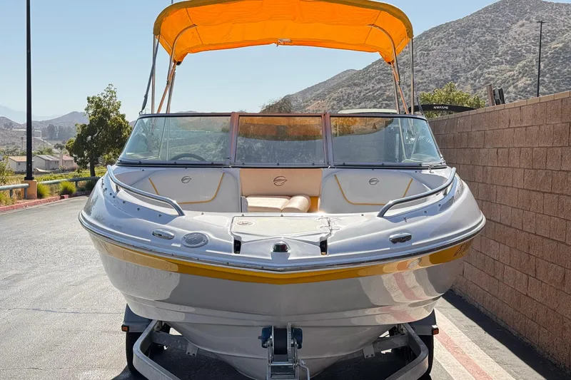 Slide: The Image of 2008 Crownline 200 LS boat with yellow canopy, parked on a sunny day. - 2