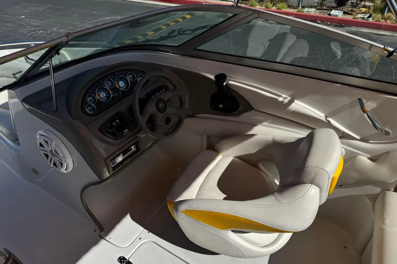 Slide: The Image of Interior of a 2008 Crownline 200 LS boat featuring steering wheel and dashboard controls. - 21