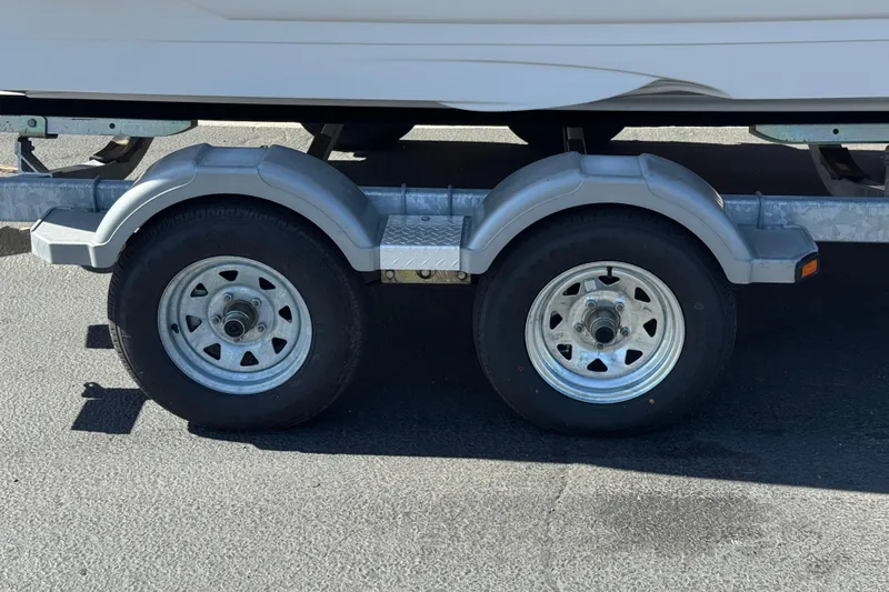 Slide: The Image of Trailer wheels of a 2008 Crownline 200 LS boat on pavement. - 24