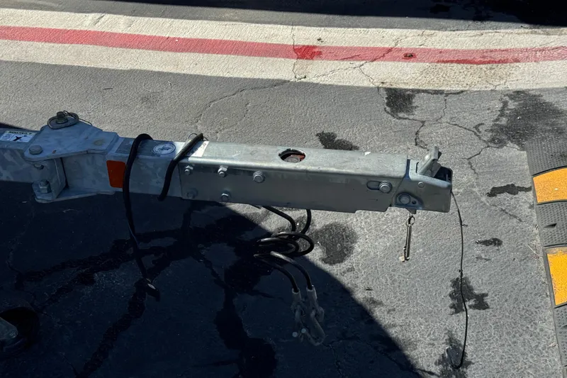 Slide: The Image of Trailer hitch of a 2008 Crownline 200 LS on cracked asphalt pavement. - 25