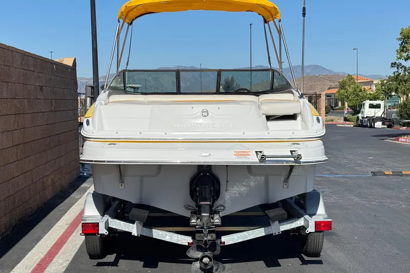 Slide: The Image of 2008 Crownline 200 LS boat with yellow canopy on trailer, parked outdoors. - 4