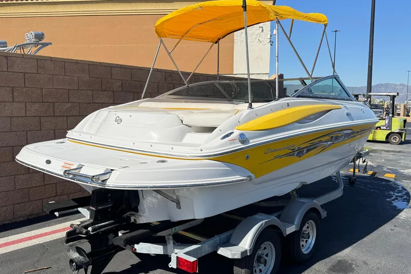 Slide: The Image of 2008 Crownline 200 LS boat with yellow accents on a trailer, parked outdoors. - 5