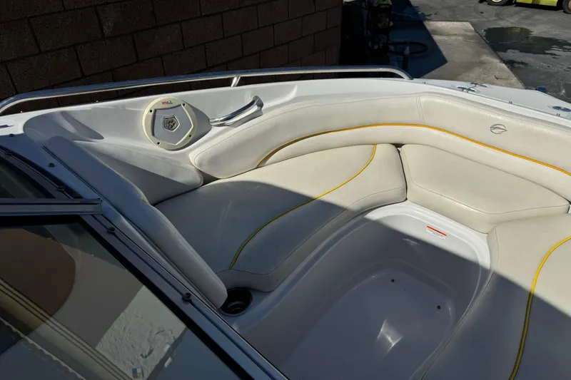 Slide: The Image of 2008 Crownline 200 LS boat interior with white seating and yellow accents. - 9