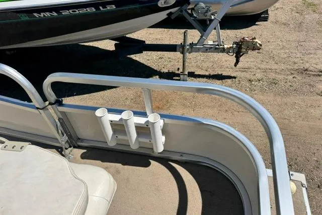 Slide: The Image of 2005 Misty Harbor 1680FS boat with rod holders and trailer hitch. - 13