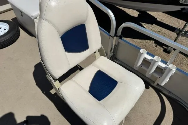 Slide: The Image of Boat seat on 2005 Misty Harbor 1680FS, featuring white and blue upholstery. - 16