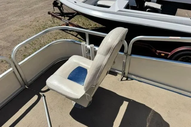 Slide: The Image of 2005 Misty Harbor 1680FS boat seat with railing, parked on a trailer. - 18