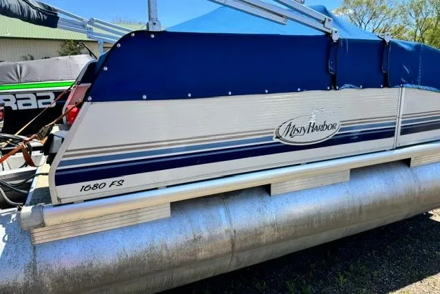Slide: The Image of 2005 Misty Harbor 1680FS pontoon boat with blue and white exterior. - 3