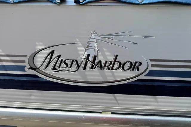 Slide: The Image of 2005 Misty Harbor 1680FS boat logo with lighthouse design on side panel. - 5