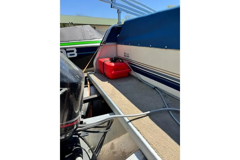 Slide: The Image of 2005 Misty Harbor 1680FS boat interior with red fuel tank and blue seating. - 8