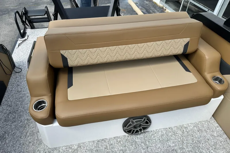 Slide: The Image of Luxurious brown seating on 2026 Revel RS25 boat with cup holders and speaker. - 11