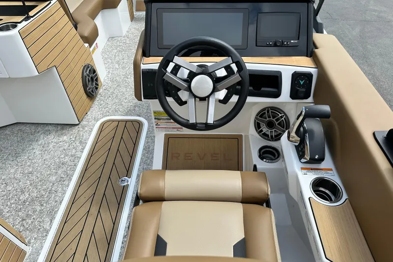 Slide: The Image of 2026 Revel RS25 boat interior with modern steering, wood accents, and advanced controls. - 12