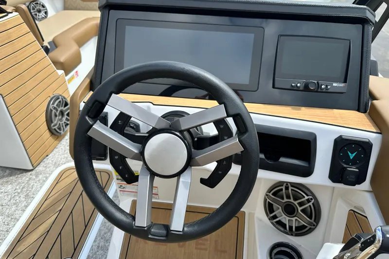 Slide: The Image of Steering wheel and dashboard of 2026 Revel RS25 boat with modern controls. - 13