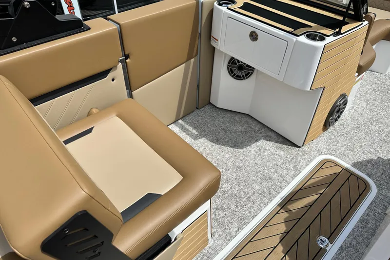 Slide: The Image of 2026 Revel RS25 boat interior with tan seating and modern console design. - 14