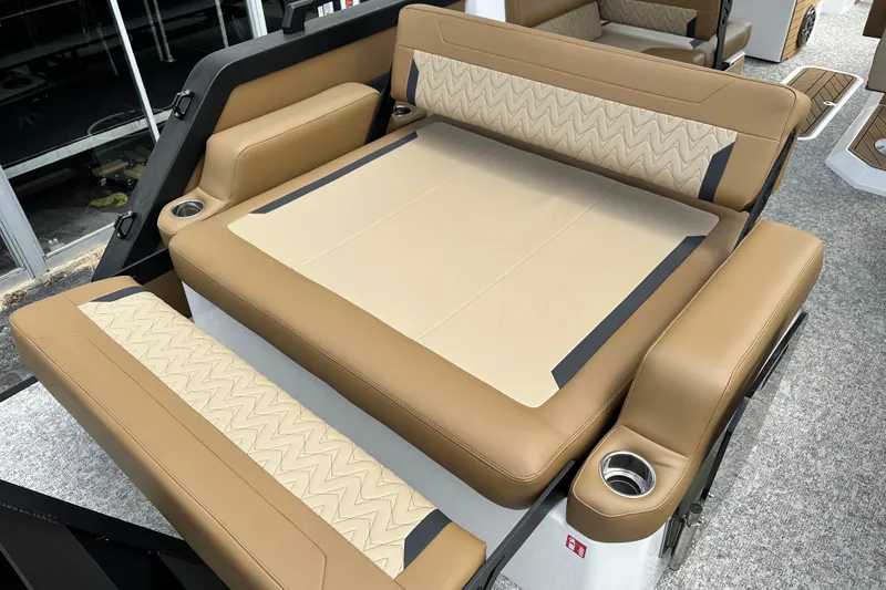 Slide: The Image of Luxurious seating area in 2026 Revel RS25 boat with tan upholstery and cup holders. - 15