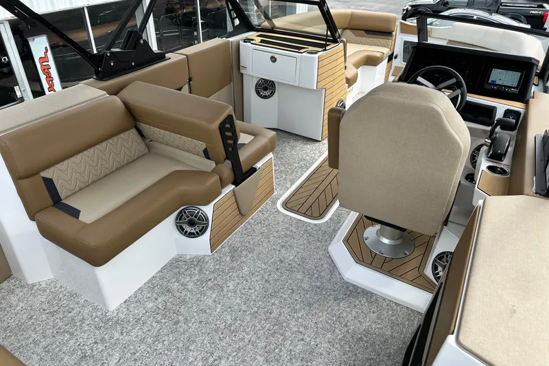 Slide: The Image of Luxurious interior of 2026 Revel RS25 boat with beige seating and modern dashboard. - 16