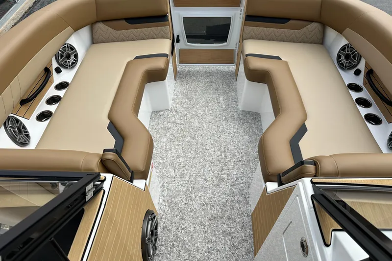 Slide: The Image of Luxurious interior of 2026 Revel RS25 boat with plush seating and modern audio system. - 17