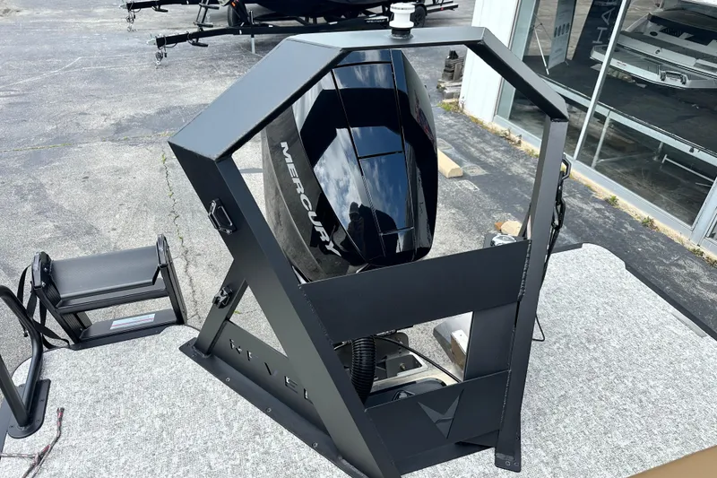 Slide: The Image of 2026 Revel RS25 boat with Mercury engine on display outdoors. - 18