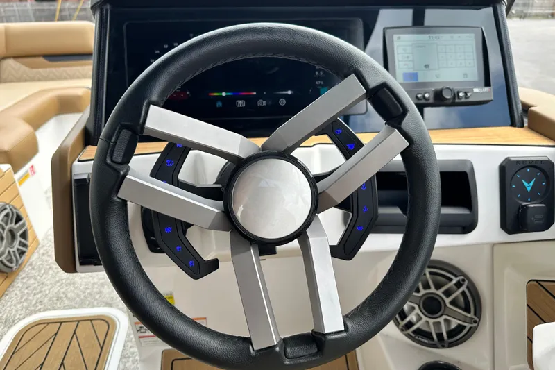 Slide: The Image of Steering wheel of 2026 Revel RS25 boat with modern dashboard and controls. - 19