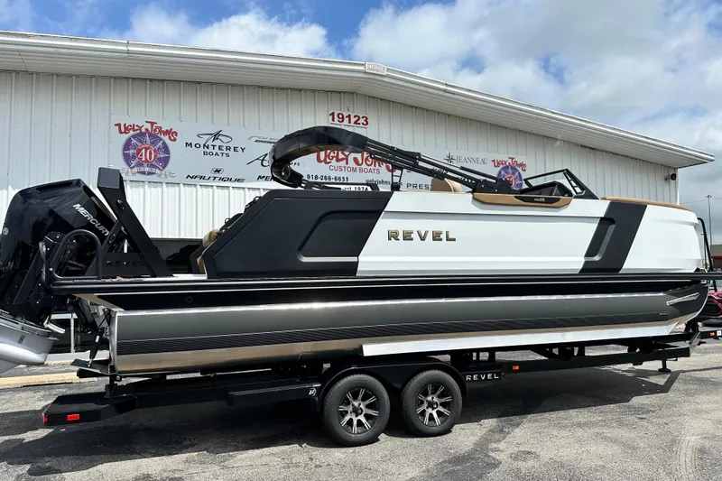 Slide: The Image of 2026 Revel RS25 boat on trailer outside dealership, showcasing sleek design and modern features. - 3