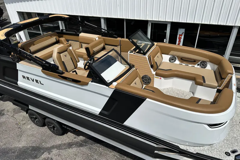 Slide: The Image of 2026 Revel RS25 boat with luxurious tan seating and modern design. - 4