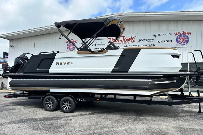 Slide: The Image of 2026 Revel RS25 boat on trailer outside dealership, showcasing sleek design and modern features. - 8