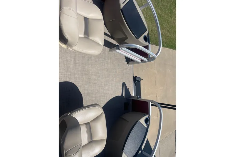 Slide: The Image of 2025 SUNTRACKER BASS BUGGY 18 interior with beige seating and railing. - 10