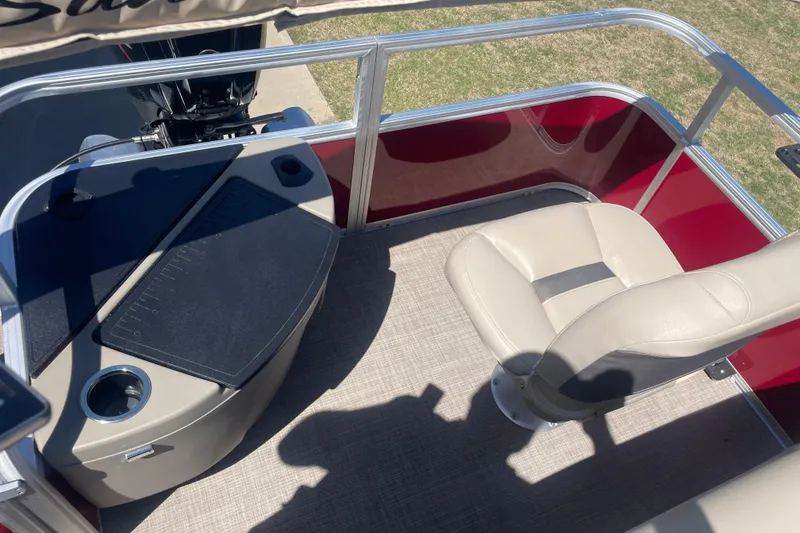 Slide: The Image of 2025 SUNTRACKER BASS BUGGY 18 boat interior with seating and fishing station. - 11
