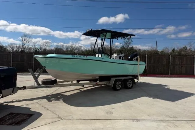The Image of 1988 Wellcraft V-20 Sport boat on trailer, parked outdoors under a clear sky. - 0
