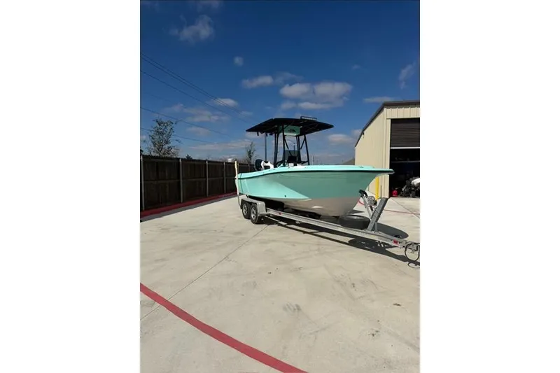 Slide: The Image of 1988 Wellcraft V-20 Sport boat on trailer, parked outdoors under clear blue sky. - 2