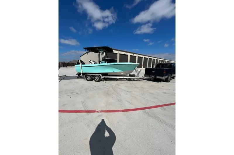 Slide: The Image of 1988 Wellcraft V-20 Sport boat on trailer, parked outdoors under blue sky. - 3