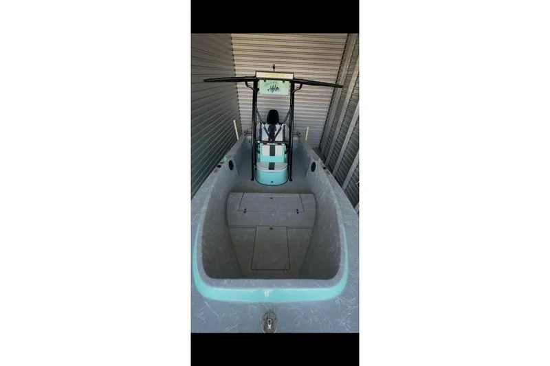 Slide: The Image of 1988 Wellcraft V-20 Sport boat interior, featuring a spacious deck and center console. - 5