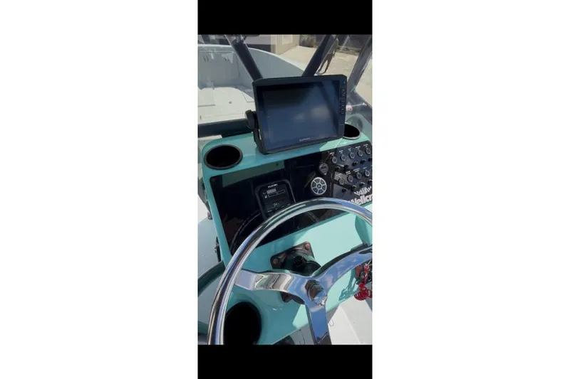 Slide: The Image of 1988 Wellcraft V-20 Sport boat dashboard with steering wheel and navigation equipment. - 7