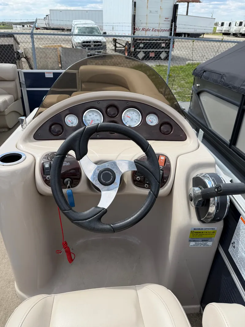 Slide: The Image of Steering console of a 2016 Starcraft Stardeck 206 Cruise boat. - 6