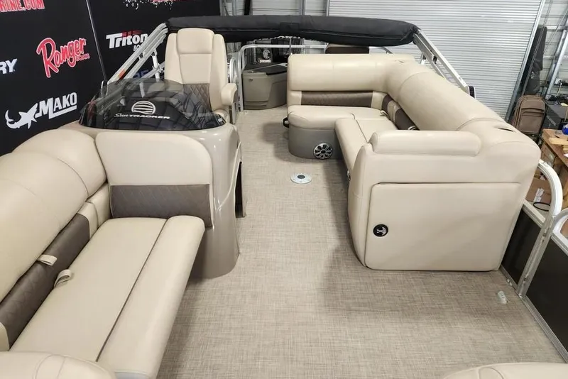 Slide: The Image of 2023 Sun Tracker Fishin' Barge 20 DLX interior with beige seating and helm. - 6