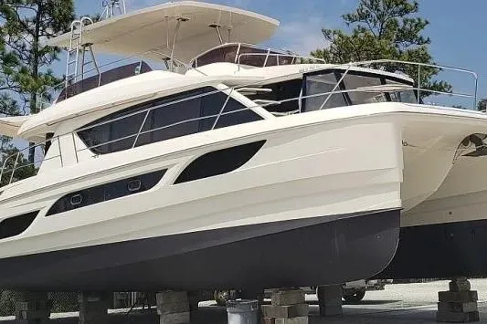 Slide: The Image of 2014 Aquila 48 yacht on dry dock, showcasing sleek design and modern features. - 12