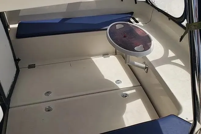 Slide: The Image of Interior seating area of a 2014 Aquila 48 boat with a small table. - 5