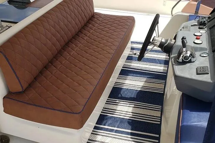 Slide: The Image of Brown quilted seating and control panel on 2014 Aquila 48 boat. - 6