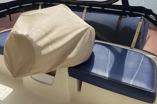 Slide: The Image of Covered helm seat on 2014 Aquila 48 boat with blue cushions. - 9