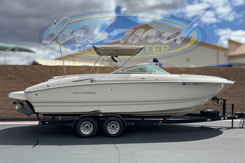 The Image of 2002 Monterey 248LS Montura Bowrider on trailer, parked outdoors under cloudy sky. - 0