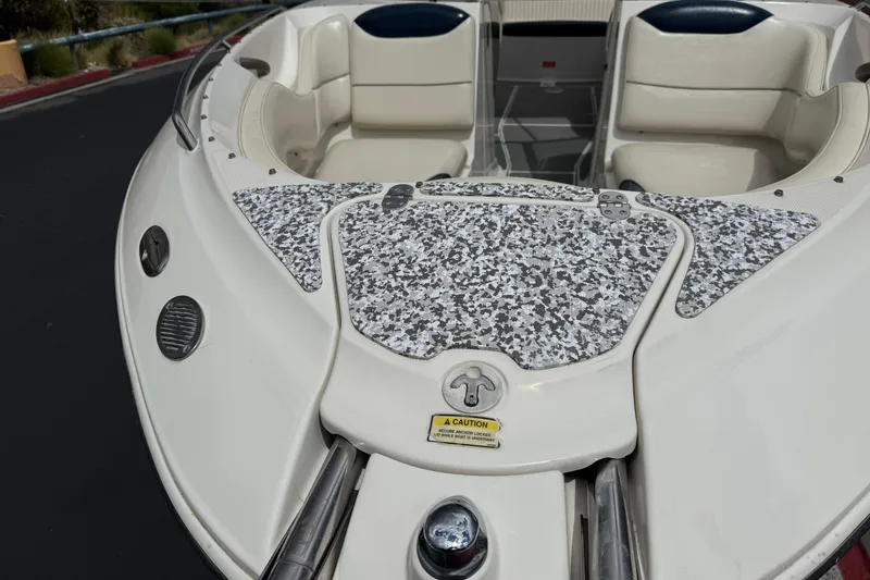 Slide: The Image of 2002 Monterey 248LS Montura Bowrider boat with patterned deck and cushioned seating. - 12