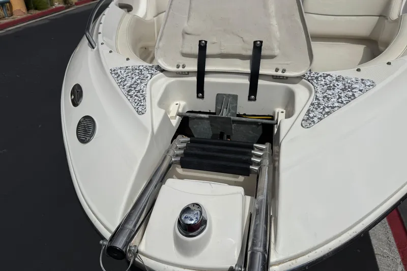 Slide: The Image of 2002 Monterey 248LS Montura Bowrider with open storage compartment and ladder. - 13