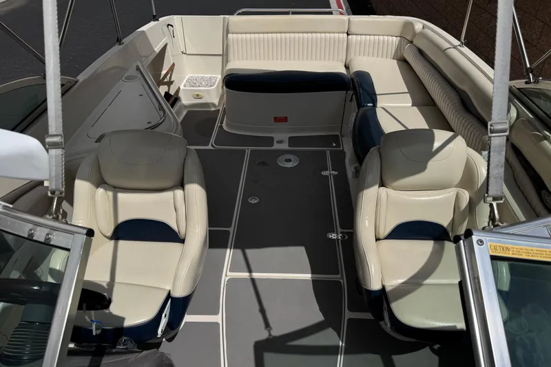 Slide: The Image of 2002 Monterey 248LS Montura Bowrider interior with beige and navy seating arrangement. - 15