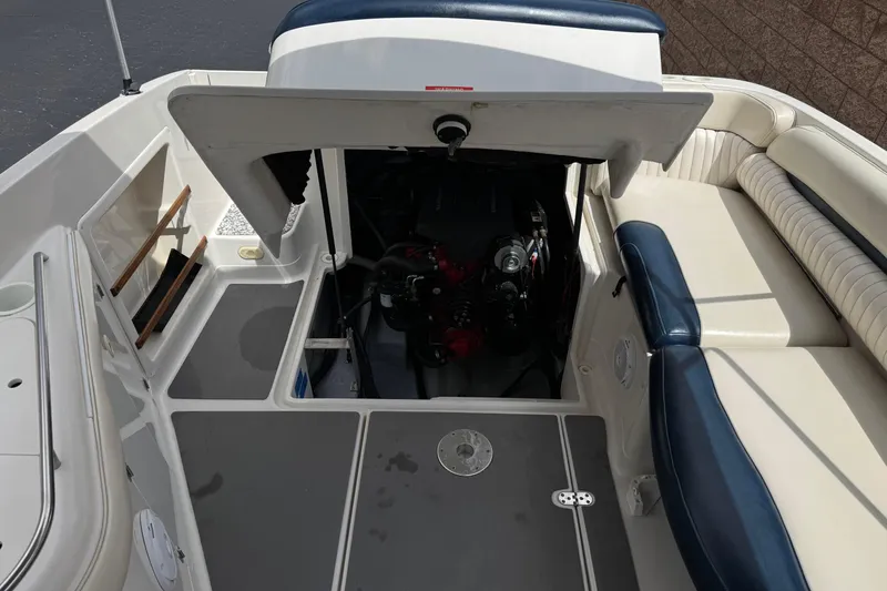 Slide: The Image of 2002 Monterey 248LS Montura Bowrider engine compartment with open hatch and seating area. - 17