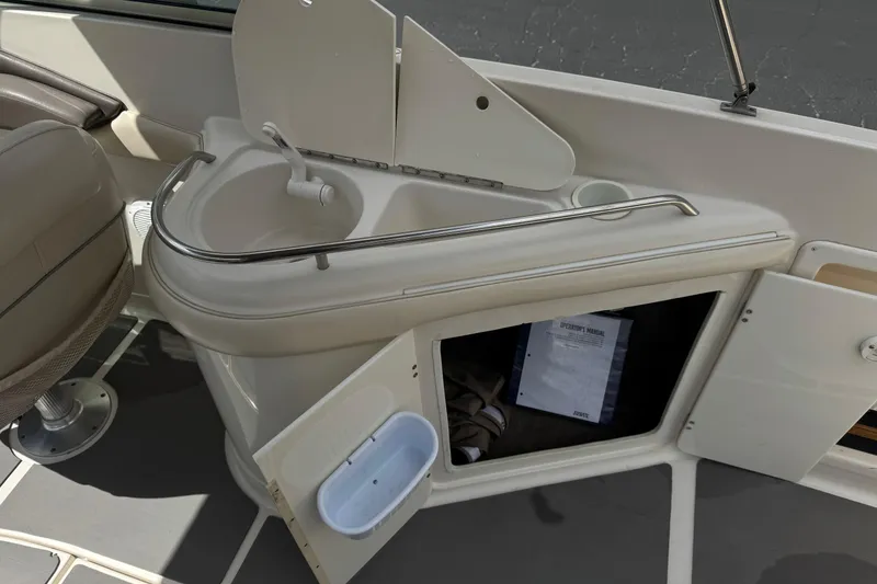 Slide: The Image of 2002 Monterey 248LS Montura Bowrider interior with sink and storage compartment. - 19