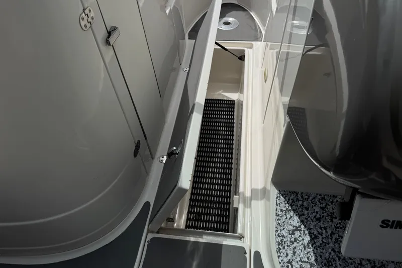 Slide: The Image of Interior view of a 2002 Monterey 248LS Montura Bowrider boat, showcasing storage compartment. - 22